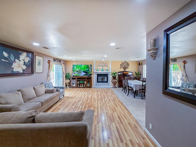 45431 Sancroft Ave, Lancaster, CA 93535 - living area featuring light wood-style flooring, recessed lighting, and a glass covered fireplace