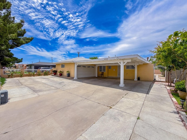 45431 Sancroft Ave, Lancaster, CA 93535 - ranch-style home with an attached garage, driveway, a gate, and a carport