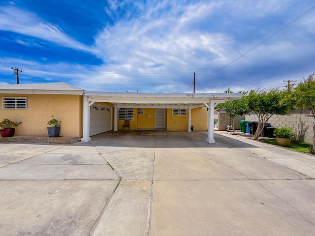 45431 Sancroft Ave, Lancaster, CA 93535 - single story home featuring concrete driveway, stucco siding, a carport, and a garage