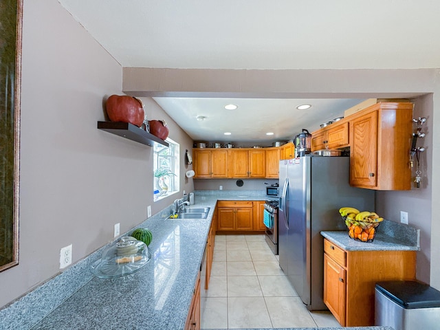 45431 Sancroft Ave, Lancaster, CA 93535 - kitchen with stainless steel appliances, a sink, brown cabinets, recessed lighting, and light tile patterned floors
