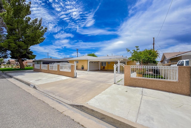 45431 Sancroft Ave, Lancaster, CA 93535 - ranch-style house featuring a fenced front yard, concrete driveway, a carport, a gate, and stucco siding