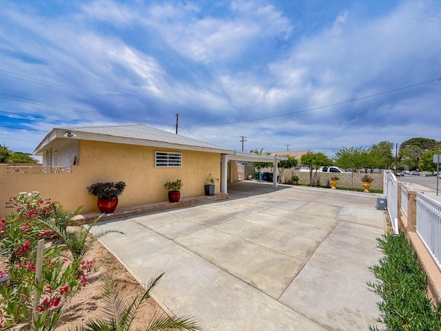 45431 Sancroft Ave, Lancaster, CA 93535 - back of property featuring stucco siding, concrete driveway, and an attached carport