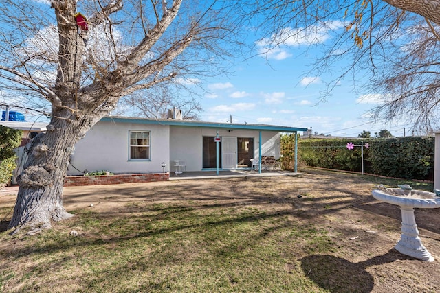 back of property featuring a yard and a patio area