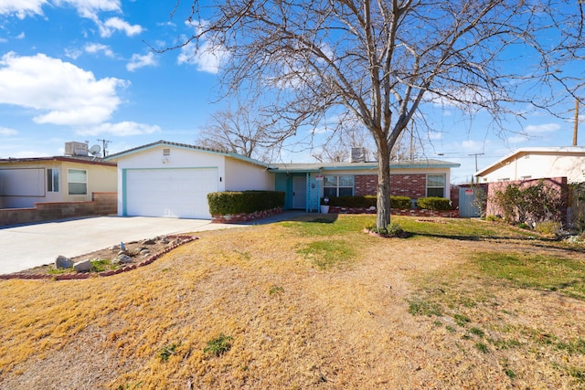 ranch-style home featuring a front yard and a garage