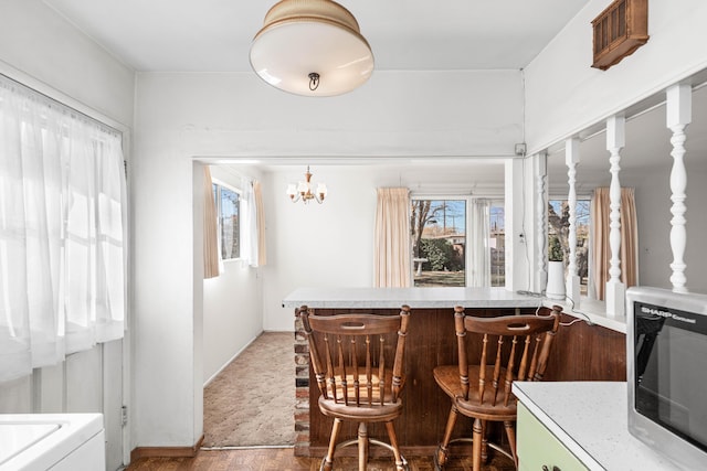 dining area with plenty of natural light and a notable chandelier