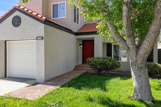 4046 Kona Ct, Palmdale, CA 93552 - view of front of house featuring stucco siding, a tile roof, a front yard, and a garage