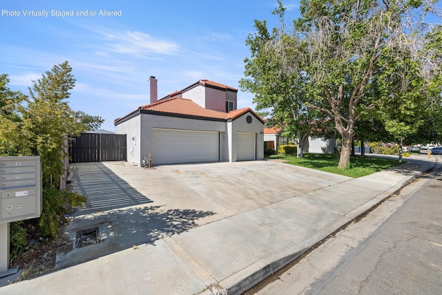 4046 Kona Ct, Palmdale, CA 93552 - mediterranean / spanish-style house featuring a garage, a tiled roof, stucco siding, and concrete driveway