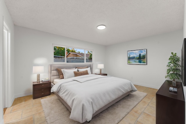 tiled bedroom featuring a textured ceiling