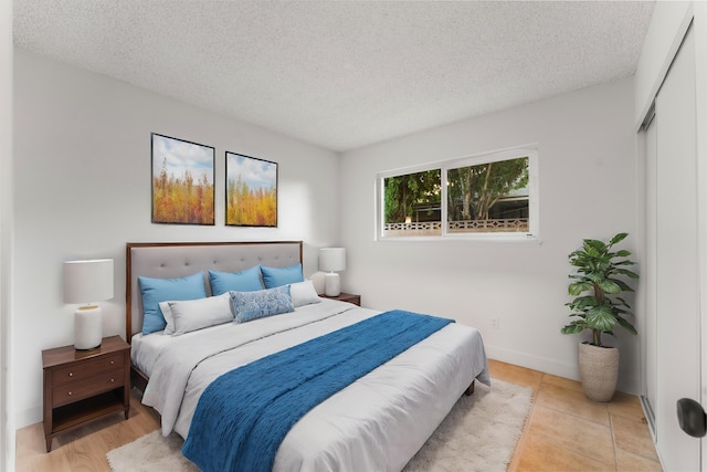 bedroom with a closet and a textured ceiling