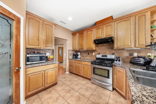 kitchen with visible vents, appliances with stainless steel finishes, under cabinet range hood, open shelves, and a sink