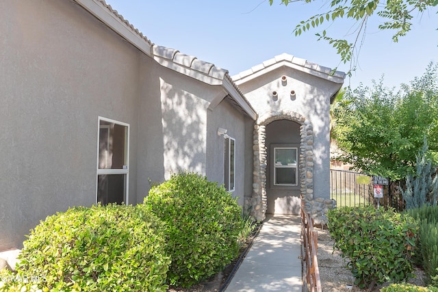 43963 Glenraven Rd, Lancaster, CA 93535 - doorway to property featuring stucco siding and a tile roof
