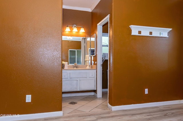 43963 Glenraven Rd, Lancaster, CA 93535 - bathroom with ornamental molding, vanity, wood finished floors, and a textured wall