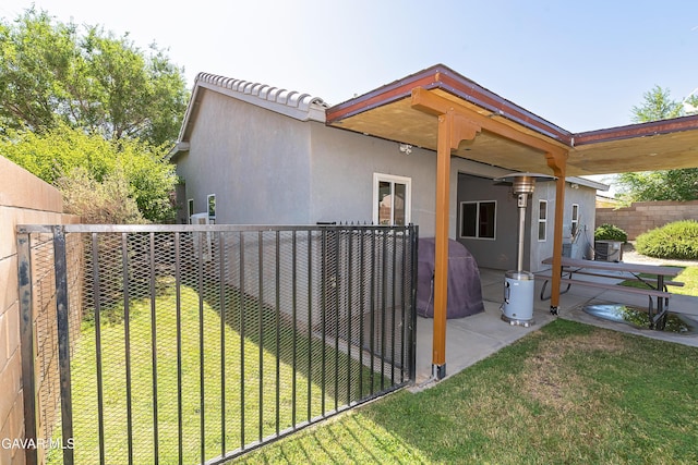 43963 Glenraven Rd, Lancaster, CA 93535 - view of home's exterior with stucco siding, a patio area, and a fenced backyard
