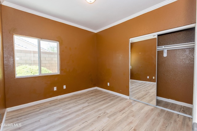 43963 Glenraven Rd, Lancaster, CA 93535 - unfurnished bedroom with wood finished floors, crown molding, and a closet