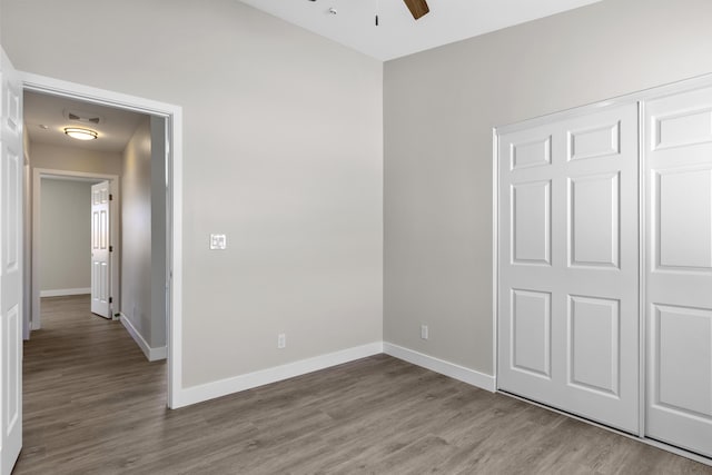 unfurnished bedroom featuring ceiling fan, a closet, and light wood-type flooring