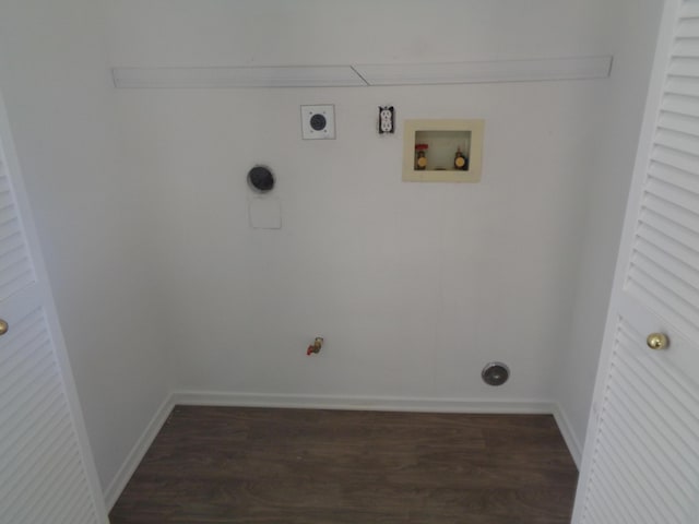 clothes washing area featuring hookup for an electric dryer, laundry area, dark wood-type flooring, washer hookup, and baseboards