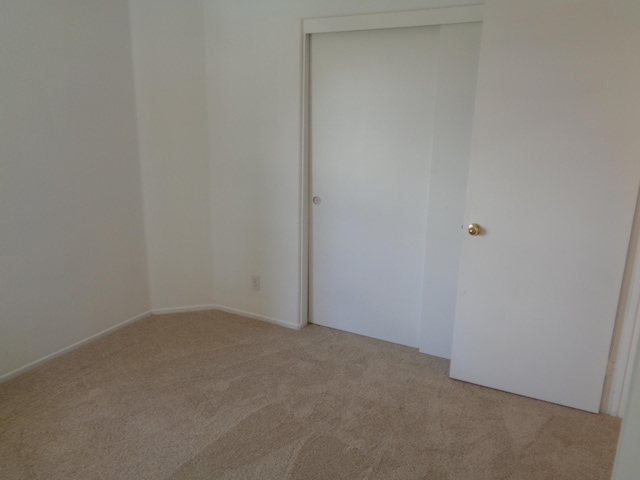 empty room featuring light carpet