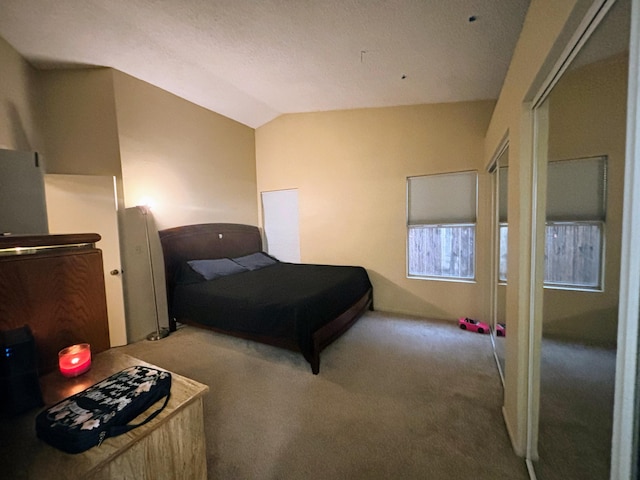 bedroom featuring vaulted ceiling and carpet floors