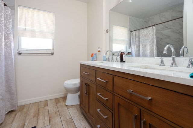 bathroom featuring vanity, hardwood / wood-style floors, and toilet