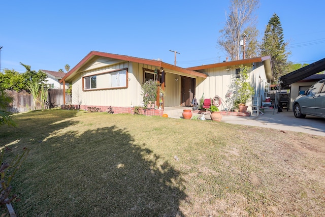 view of front facade with a patio and a front lawn