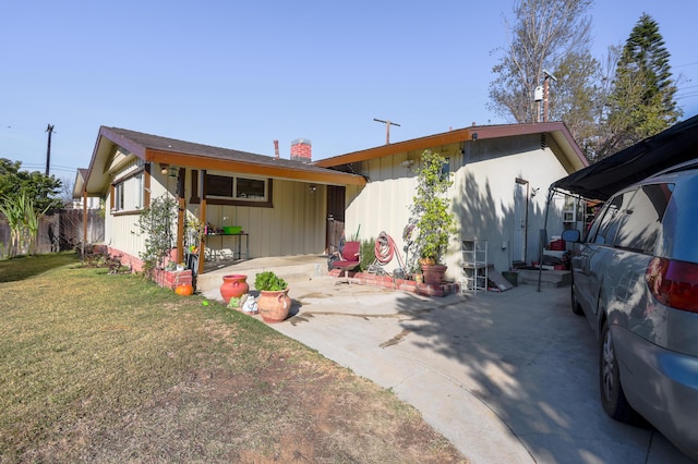 view of front of property with a front lawn and a patio