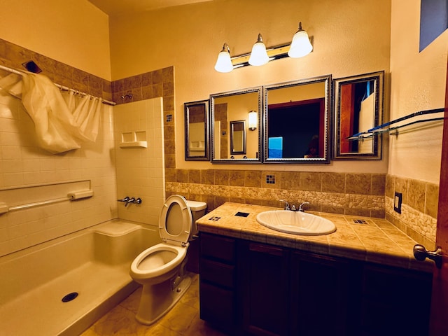 full bath with a shower, toilet, vanity, and tile walls