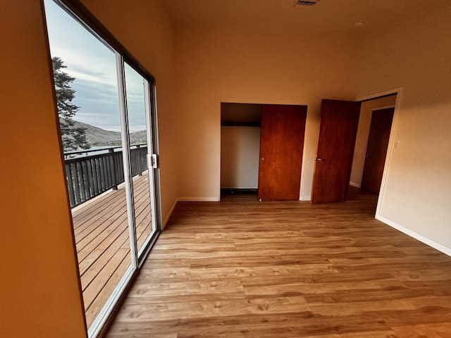 empty room featuring baseboards and light wood-type flooring