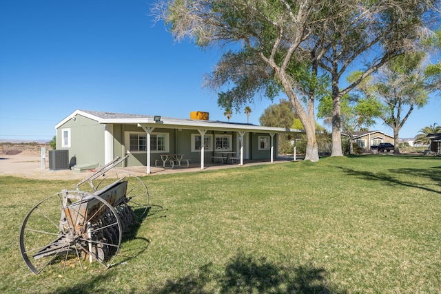 view of front of property with cooling unit, a front yard, and a patio