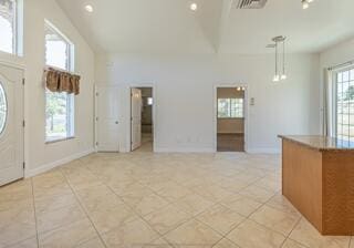 tiled foyer with a high ceiling