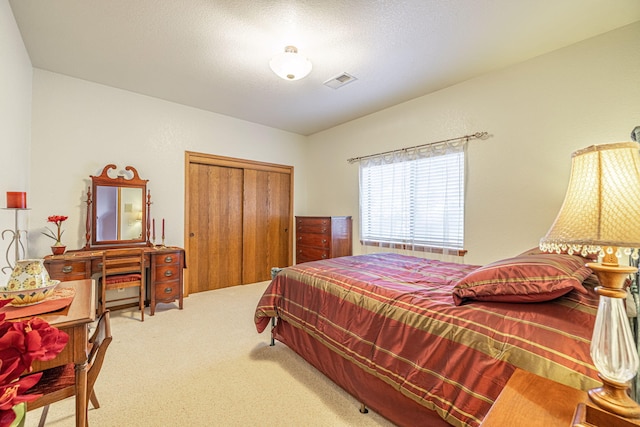 carpeted bedroom featuring a closet