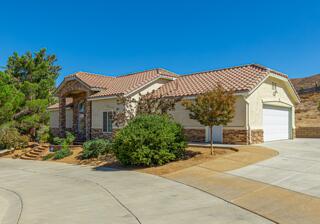 36546 El Camino Dr, Palmdale, CA 93551 - mediterranean / spanish-style home featuring a garage