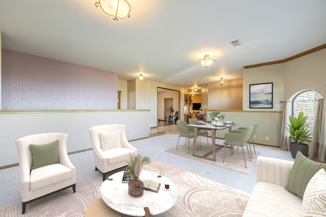 living room with light colored carpet and crown molding