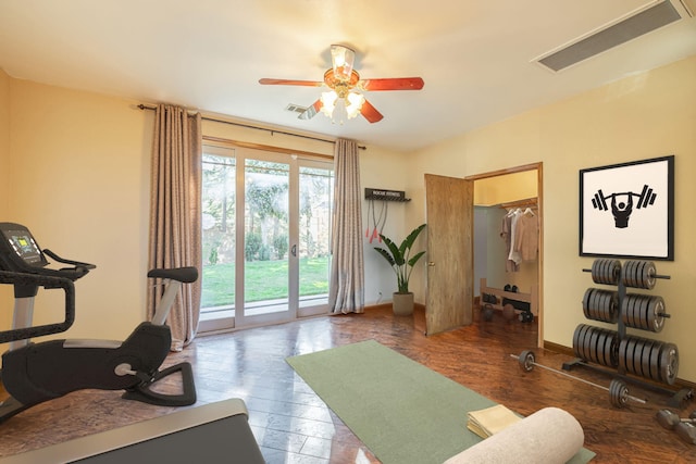 workout room with dark hardwood / wood-style flooring and ceiling fan