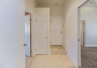 hall featuring light tile patterned flooring