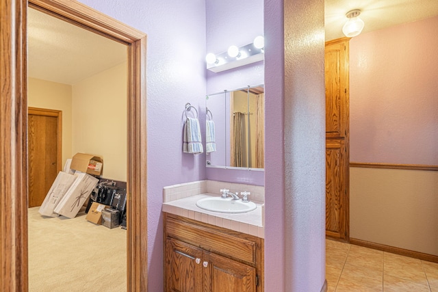 bathroom with tile patterned floors and vanity