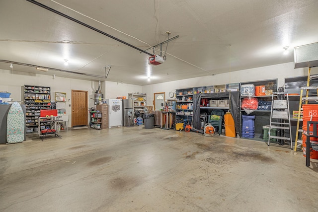 garage with stainless steel fridge and a garage door opener