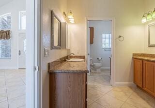 bathroom featuring tile patterned flooring, vanity, and toilet