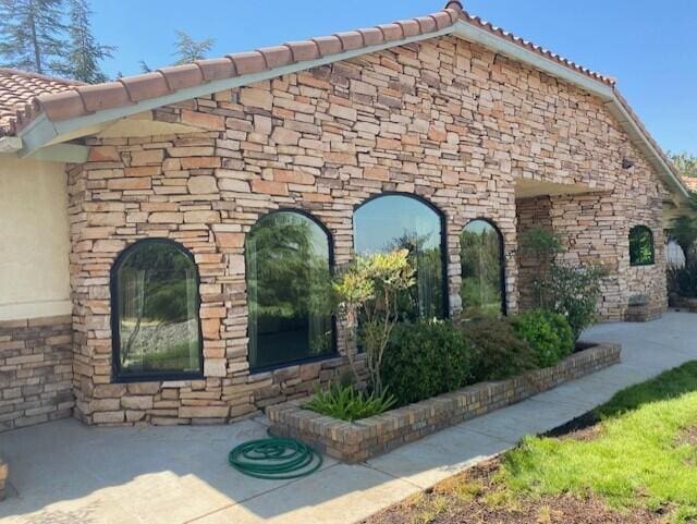 view of side of property with a patio