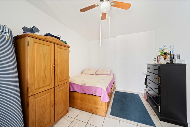 tiled bedroom featuring ceiling fan