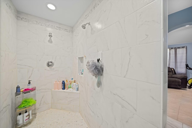 bathroom with a tile shower