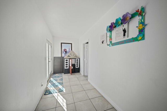 hall featuring light tile patterned flooring