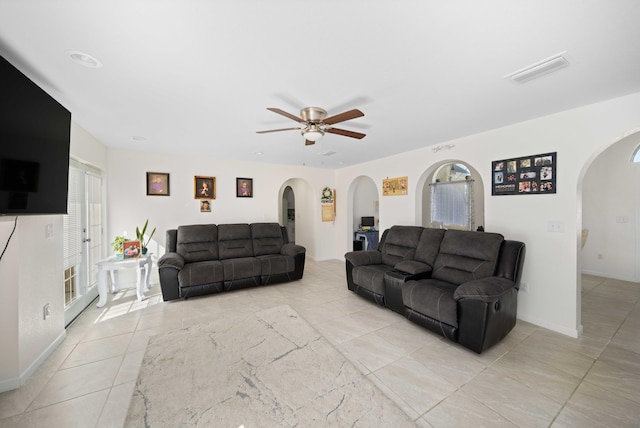 living room featuring ceiling fan and light tile patterned floors