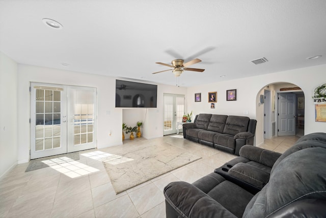 living room featuring ceiling fan, light tile patterned floors, and french doors