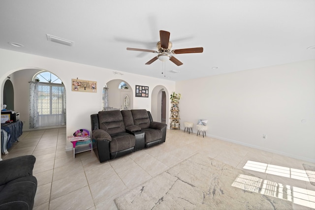 tiled living room with ceiling fan