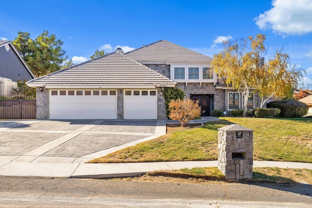 front facade featuring a garage and a front yard