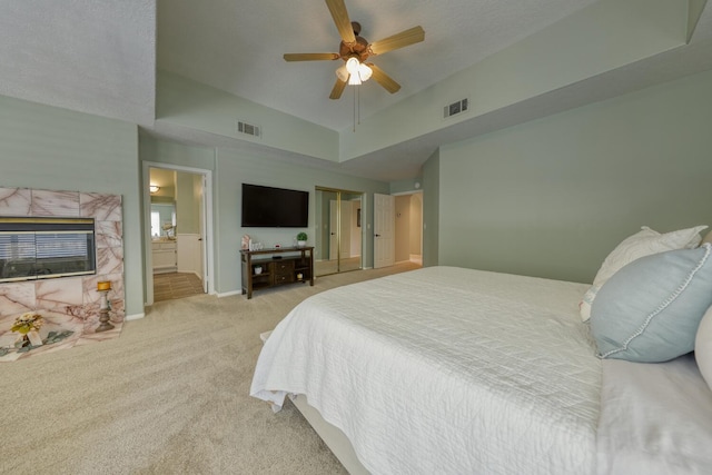 carpeted bedroom featuring connected bathroom, a ceiling fan, baseboards, and visible vents
