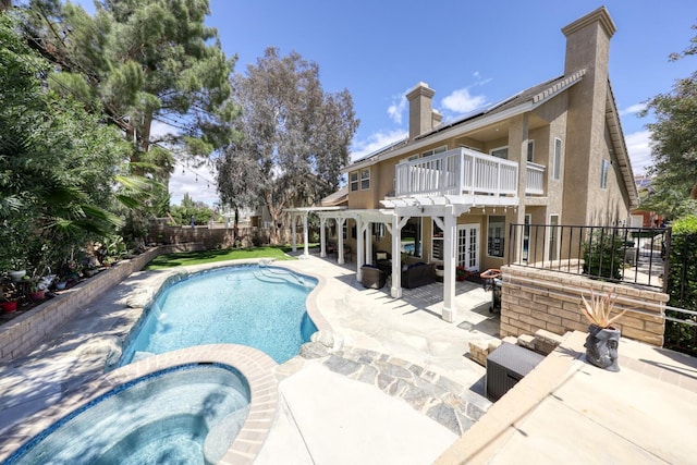 view of pool with a fenced backyard, a pergola, a pool with connected hot tub, and a patio