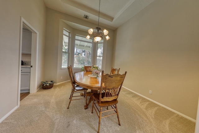 dining area with an inviting chandelier, baseboards, light carpet, and visible vents