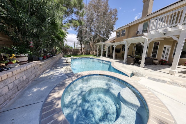 view of swimming pool with a pergola, a fenced in pool, a fenced backyard, an in ground hot tub, and french doors