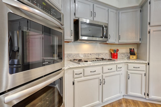 kitchen featuring light wood-style flooring and stainless steel appliances